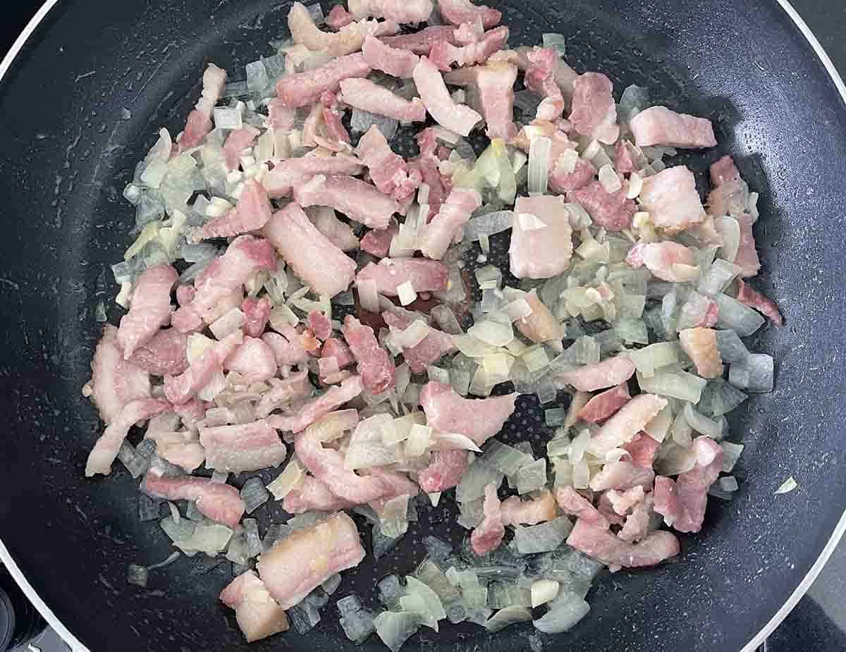 bacon and onions in a pan.