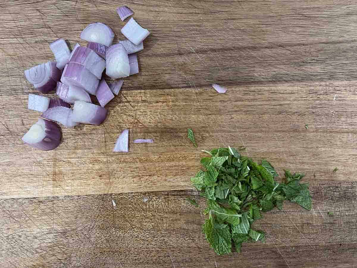 chopped shallot and mint on a board.