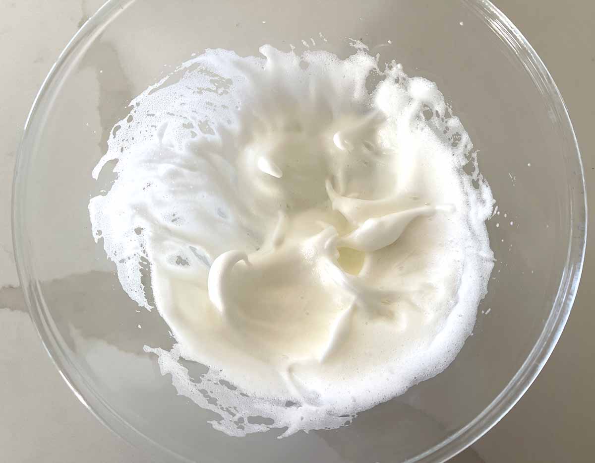 whipped egg whites in a bowl.