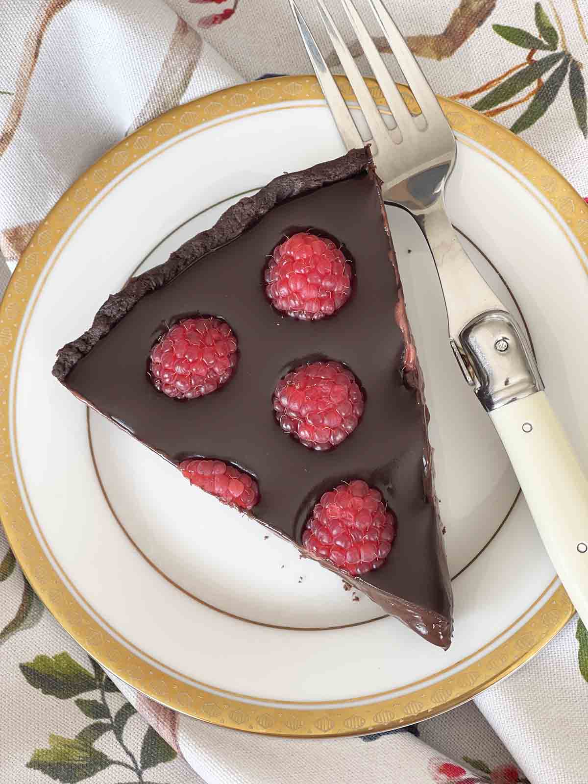 close up of slice of raspberry chocolate tart.