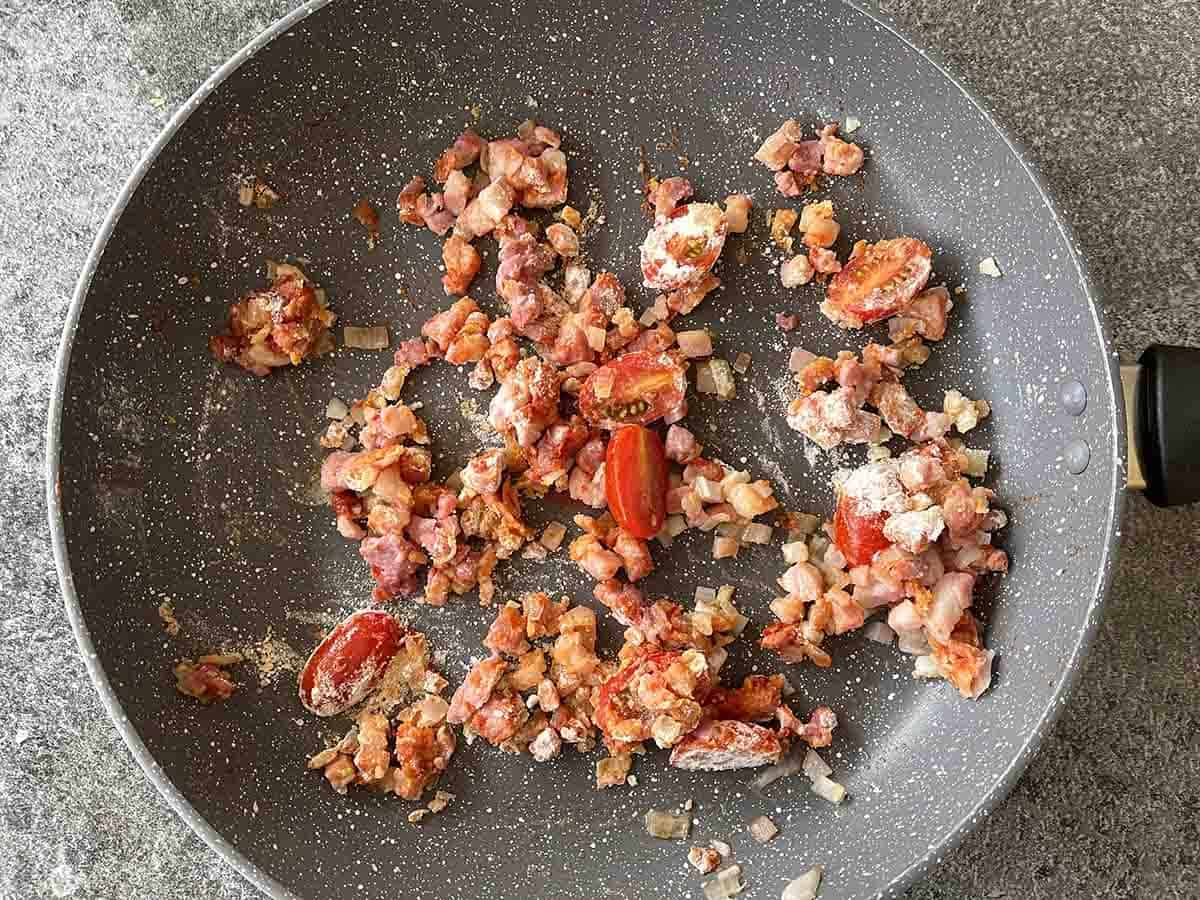 tomatoes added to pan with flour.