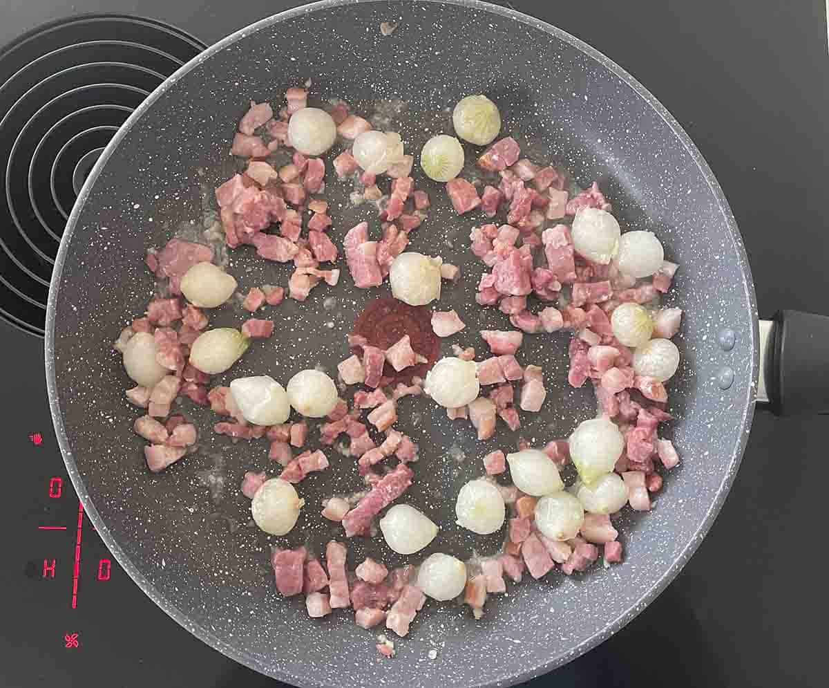 onions and bacon in a pan.