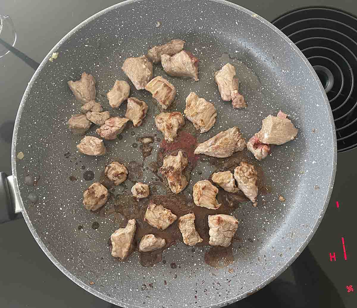beef browning in a pan.
