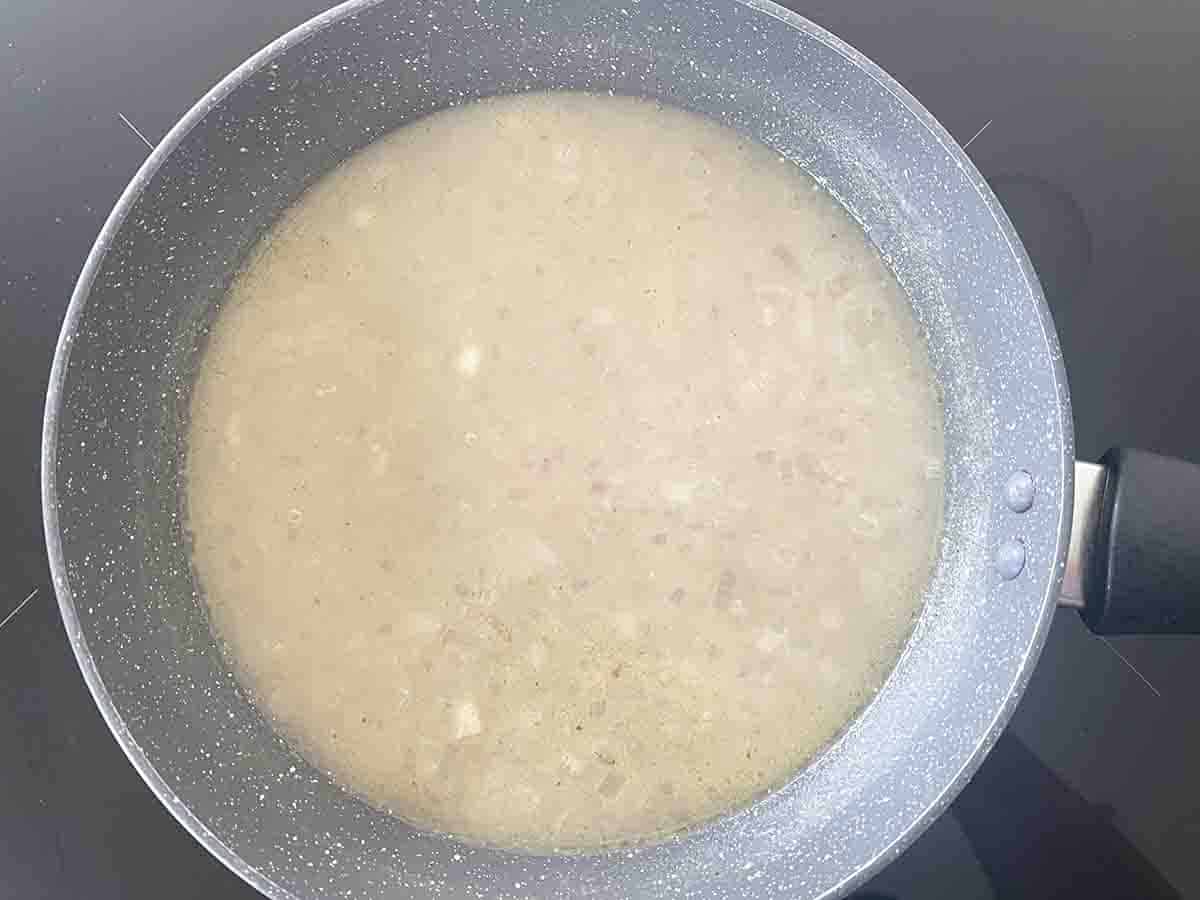 stock and wine added to the shallots.