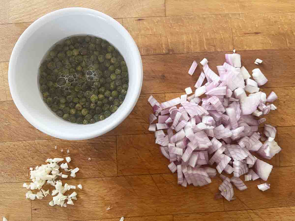 chopped shallot and garlic on a board.
