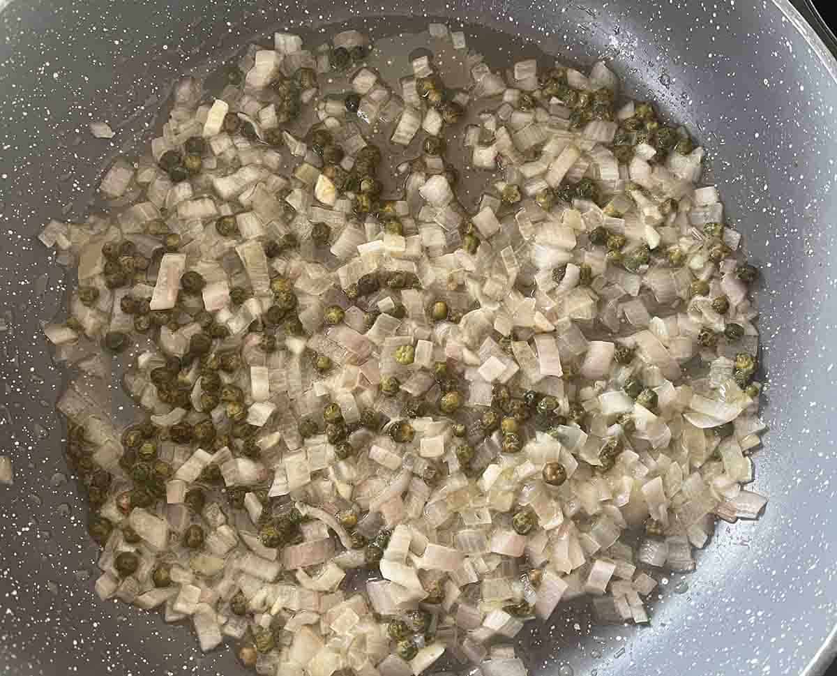 shallot, garlic and peppercrns in a pan.