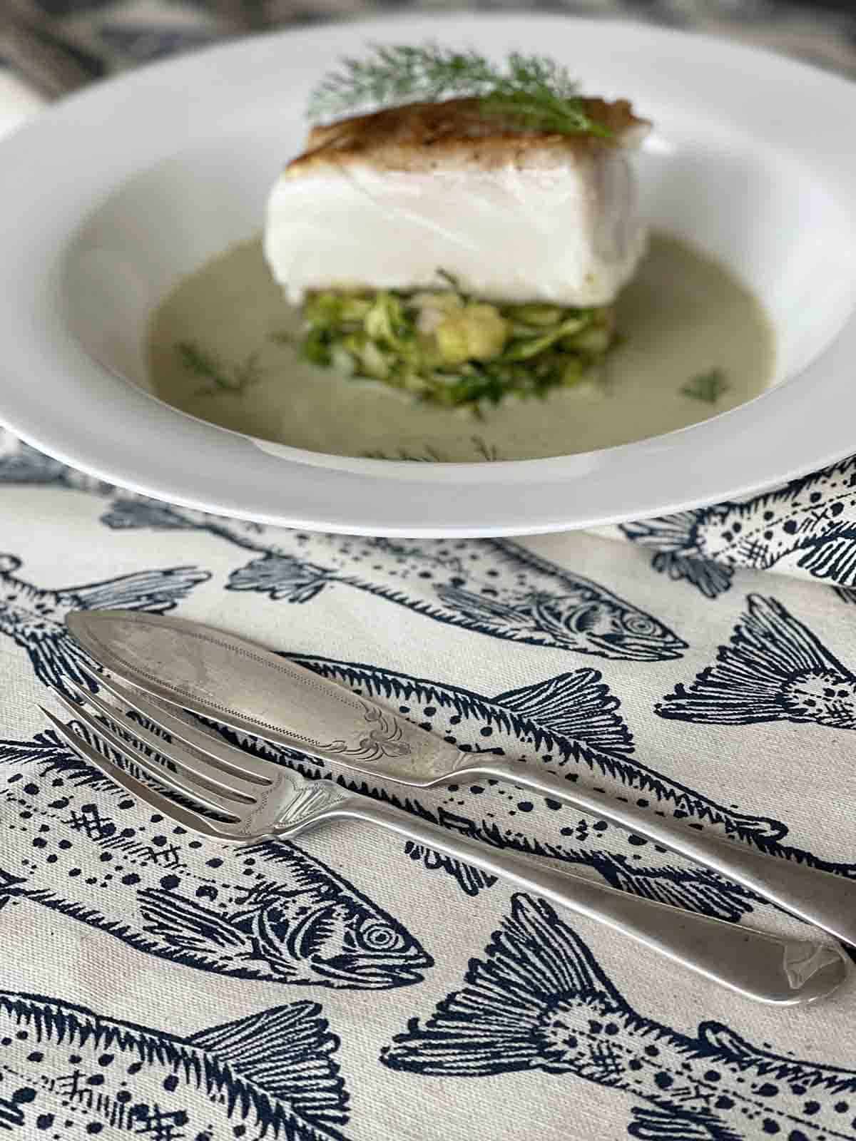 plate of halibut with veloute sauce.